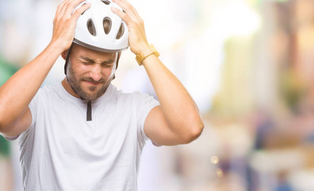 istock Young handsome man wearing cyclist safety helmet over isolated background suffering from headache desperate and stressed because pain and migraine. Hands on head. 1097765880