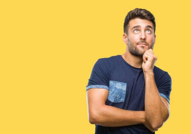 istock Young handsome man over isolated background with hand on chin thinking about question, pensive expression. Smiling with thoughtful face. Doubt concept. 1097766108
