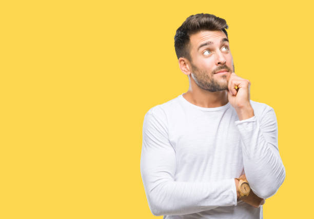istock Young handsome man over isolated background with hand on chin thinking about question, pensive expression. Smiling with thoughtful face. Doubt concept. 1097766308