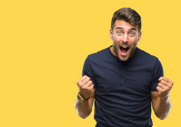 istock Young handsome man over isolated background celebrating surprised and amazed for success with arms raised and open eyes. Winner concept. 1097766400