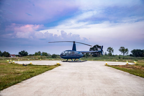 istock Helicopter on helipad with landing lights on at dusk 1097766462