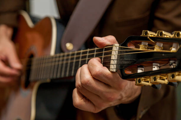 istock musician plays guitar close up 1097767674