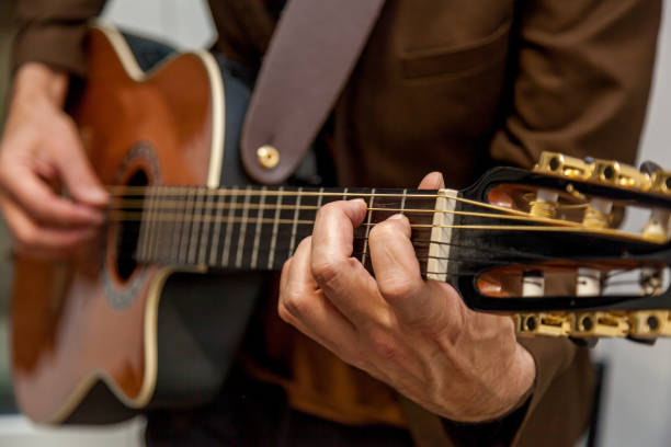istock musician plays guitar close up 1097767690
