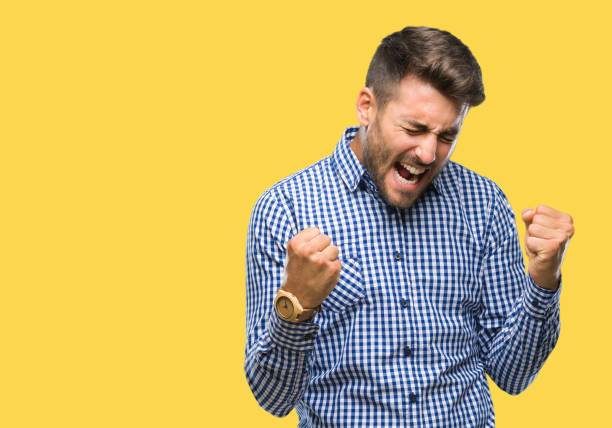 istock Young handsome man over isolated background very happy and excited doing winner gesture with arms raised, smiling and screaming for success. Celebration concept. 1097767854