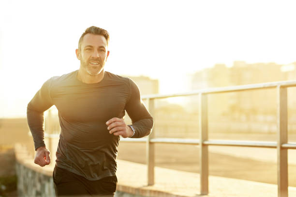 Shot of a mature man running on the promenade as part of his exercise routine