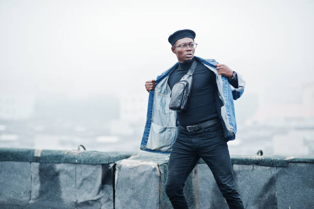 istock African american man in jeans jacket, beret and eyeglasses 1097773106