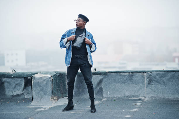 istock African american man in jeans jacket, beret and eyeglasses 1097773174