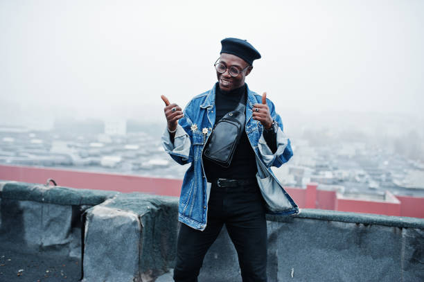 istock African american man in jeans jacket, beret and eyeglasses 1097773190