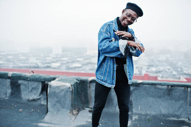istock African american man in jeans jacket, beret and eyeglasses 1097773202