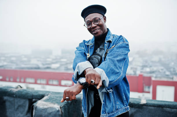 istock African american man in jeans jacket, beret and eyeglasses 1097773204