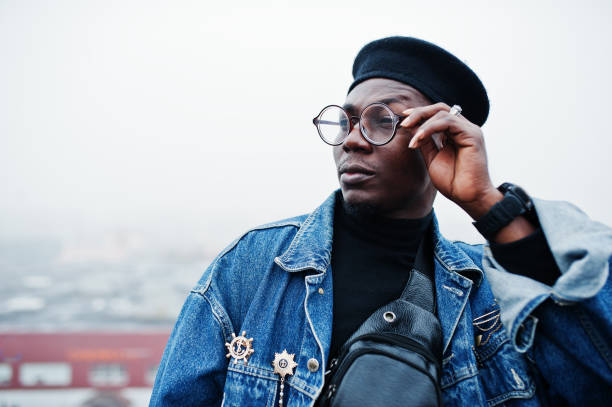 istock African american man in jeans jacket, beret and eyeglasses 1097773270