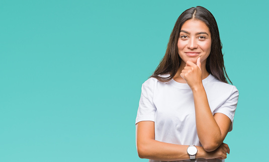 Young beautiful arab woman over isolated background looking confident at the camera with smile with crossed arms and hand raised on chin. Thinking positive.