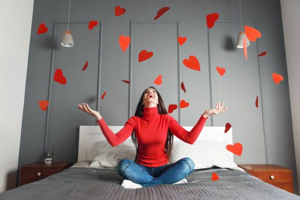istock Beautiful young woman with red hearts 1097774930