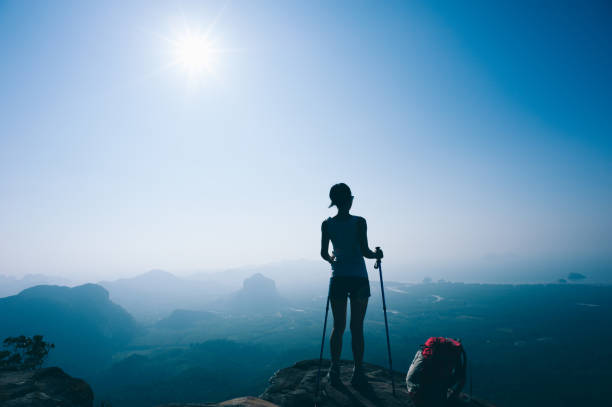 istock successful hiker hiking on sunset mountain peak 1097775322
