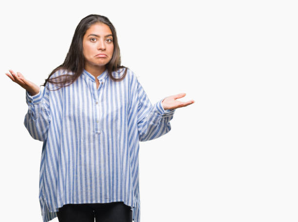 istock Young beautiful arab woman over isolated background clueless and confused expression with arms and hands raised. Doubt concept. 1097775512