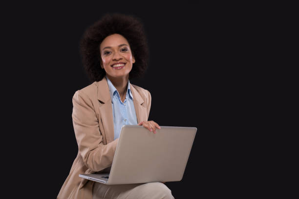 istock Young woman using laptop and smiling 1097775588
