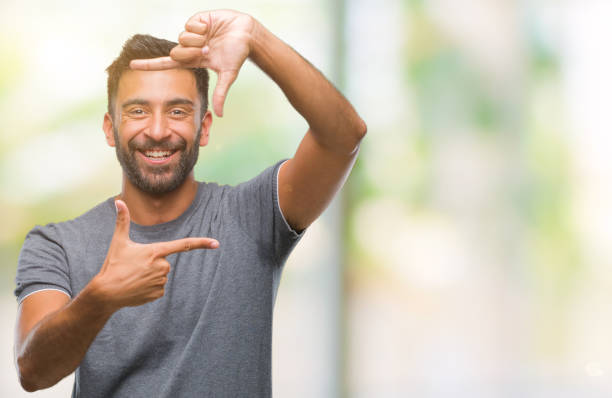 istock Adult hispanic man over isolated background smiling making frame with hands and fingers with happy face. Creativity and photography concept. 1097775932