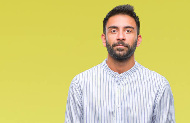 istock Adult hispanic man over isolated background with serious expression on face. Simple and natural looking at the camera. 1097777034