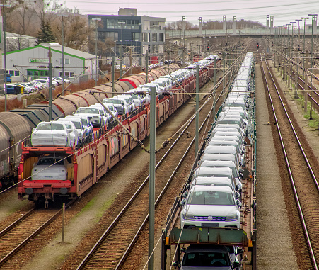 Wolfsburg, Germany, January 14., 2019: Transfer yard in Fallersleben with freight trains loaded with new Volkswagen cars and waiting to be transported away