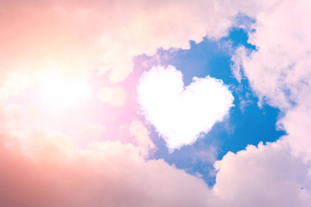 cloud heart in the sky in the clouds and sunshine. - love imagens e fotografias de stock
