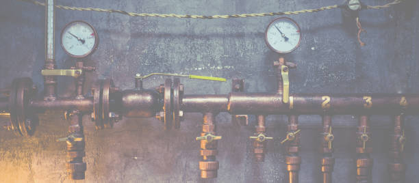 istock Plumbing pipes against a gray wall in style loft 1097780934
