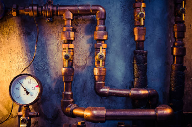 istock Plumbing pipes against a gray wall in style loft 1097780940