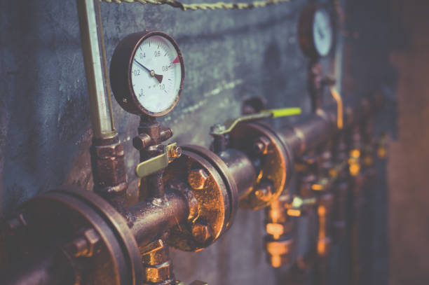 istock Plumbing pipes against a gray wall in style loft 1097781002