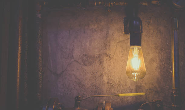 istock Led lamp shines yellow light against a gray wall 1097781352