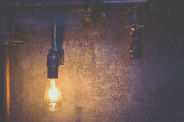 istock Led lamp shines yellow light against a gray wall 1097781354