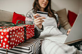 Young woman shopping from home for Christmas