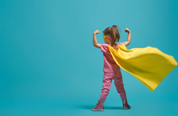 child playing superhero stock photo