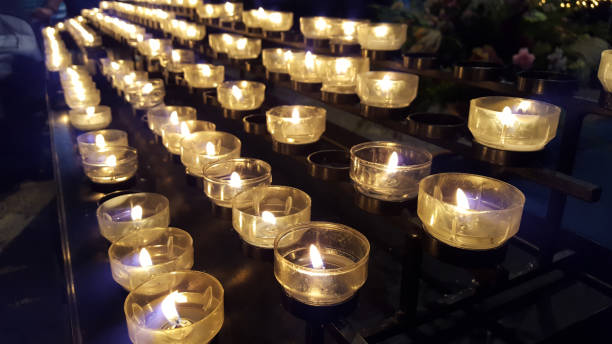 istock burning candles in a church - symbol for mourning, commemoration, devotion 1097784196