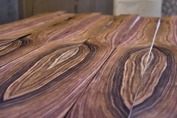Veneer Santos Rosewood. Wood texture. Woodworking and carpentry production. Close-up. Furniture manufacture