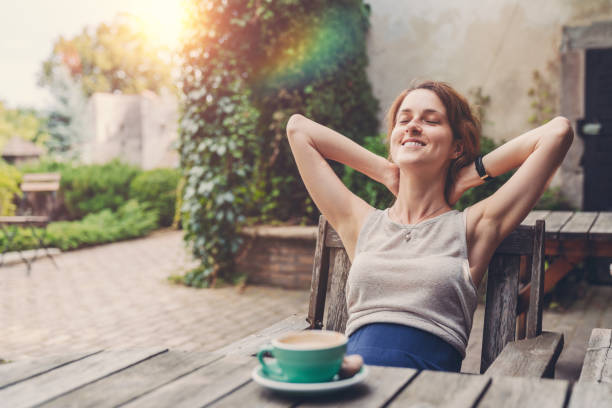 Relaxed woman drinking coffee in the garden