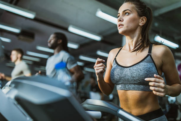 istock Determined female athlete jogging on treadmill in a gym. 1097784936