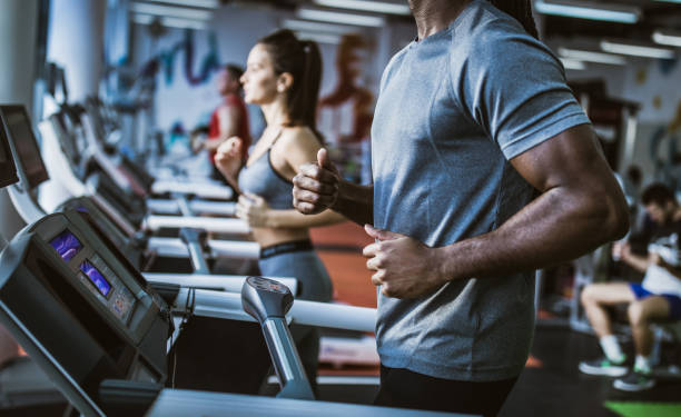 istock Unrecognizable black athlete jogging on treadmill in a gym. 1097787088