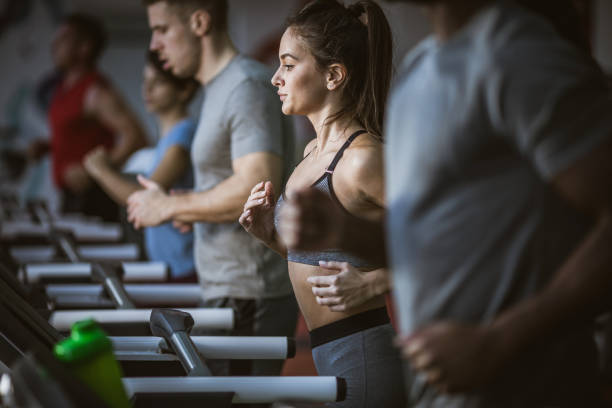 istock Group of young athletes warming up on treadmills in a gym. 1097787910