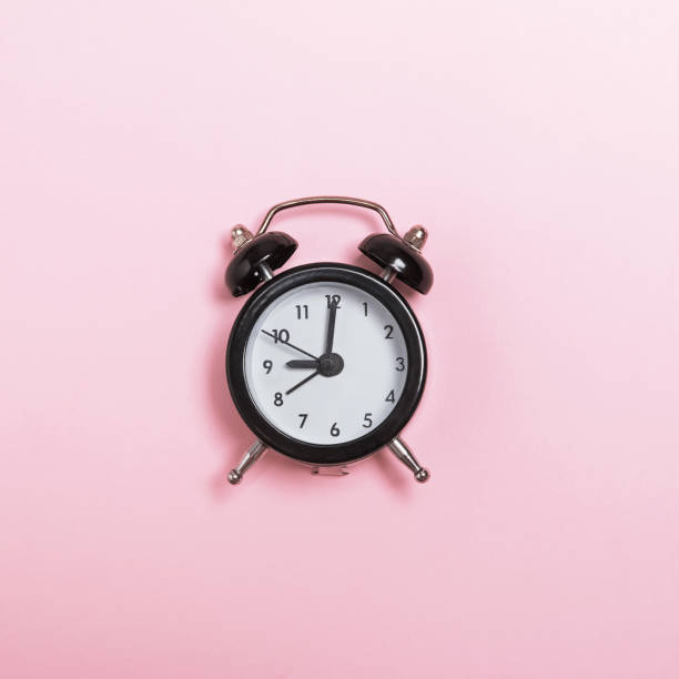 istock Small alarm clock isolated on pastel pink background 1097790052