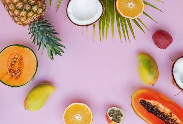 istock Creative frame with tropic fruits on the pink background 1097790090
