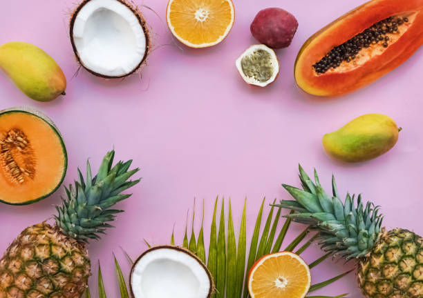 istock Creative frame with tropic fruits on the pink background 1097790100