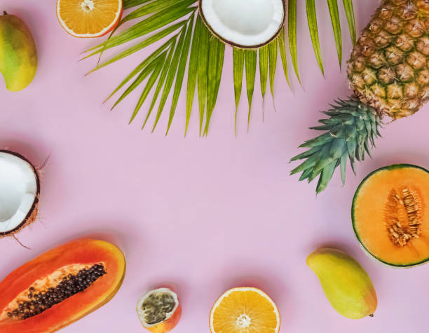 istock Creative frame with tropic fruits on the pink background 1097790102