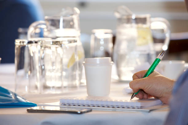 Man Taking Notes at a Breakfast Meeting stock photo