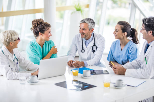istock Team of happy general practitioners talking on a meeting at doctor's office. 1097793088