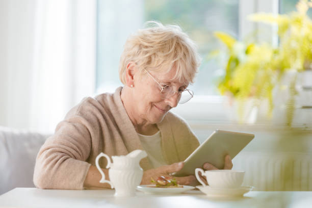 istock Pleased senior woman using digital tablet 1097793500
