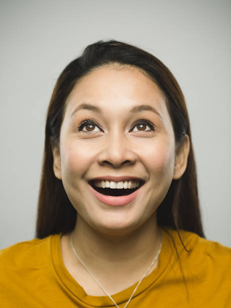 Real malaysian young woman with very excited expression looking up