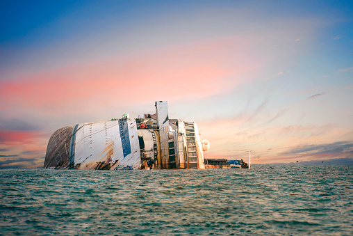 disaster of the passenger vessel capsize and sunk into the sea ocean at sunset