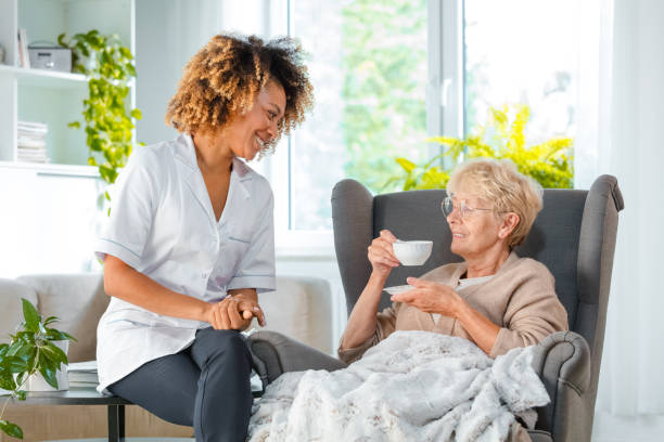istock Cheerful nurse taking care of elderly lady 1097799628