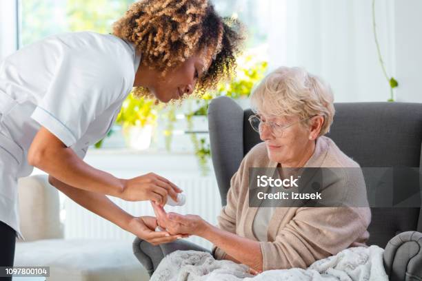 Home Nurse Giving Pills An Elderly Lady Stock Photo - Download Image Now - Disability, Support, Charity and Relief Work