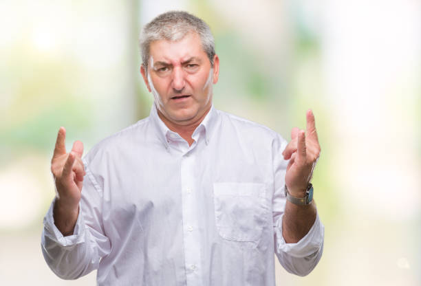 istock Handsome senior man over isolated background shouting with crazy expression doing rock symbol with hands up. Music star. Heavy concept. 1097800872