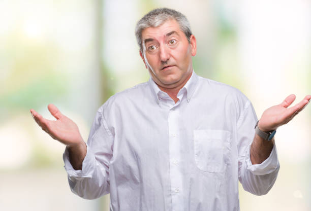 istock Handsome senior man over isolated background clueless and confused expression with arms and hands raised. Doubt concept. 1097800882